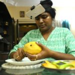 AI robotics training data graphic showing an Indian worker wearing a head camera while recording household tasks