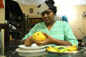AI robotics training data graphic showing an Indian worker wearing a head camera while recording household tasks