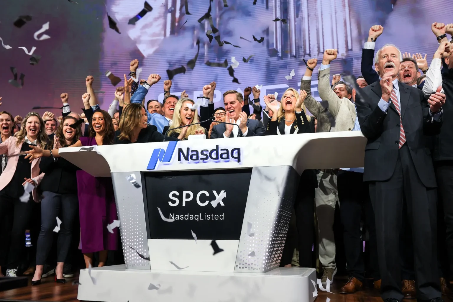 SpaceX IPO graphic showing Nasdaq, rocket launch, AI infrastructure and public market pressure
